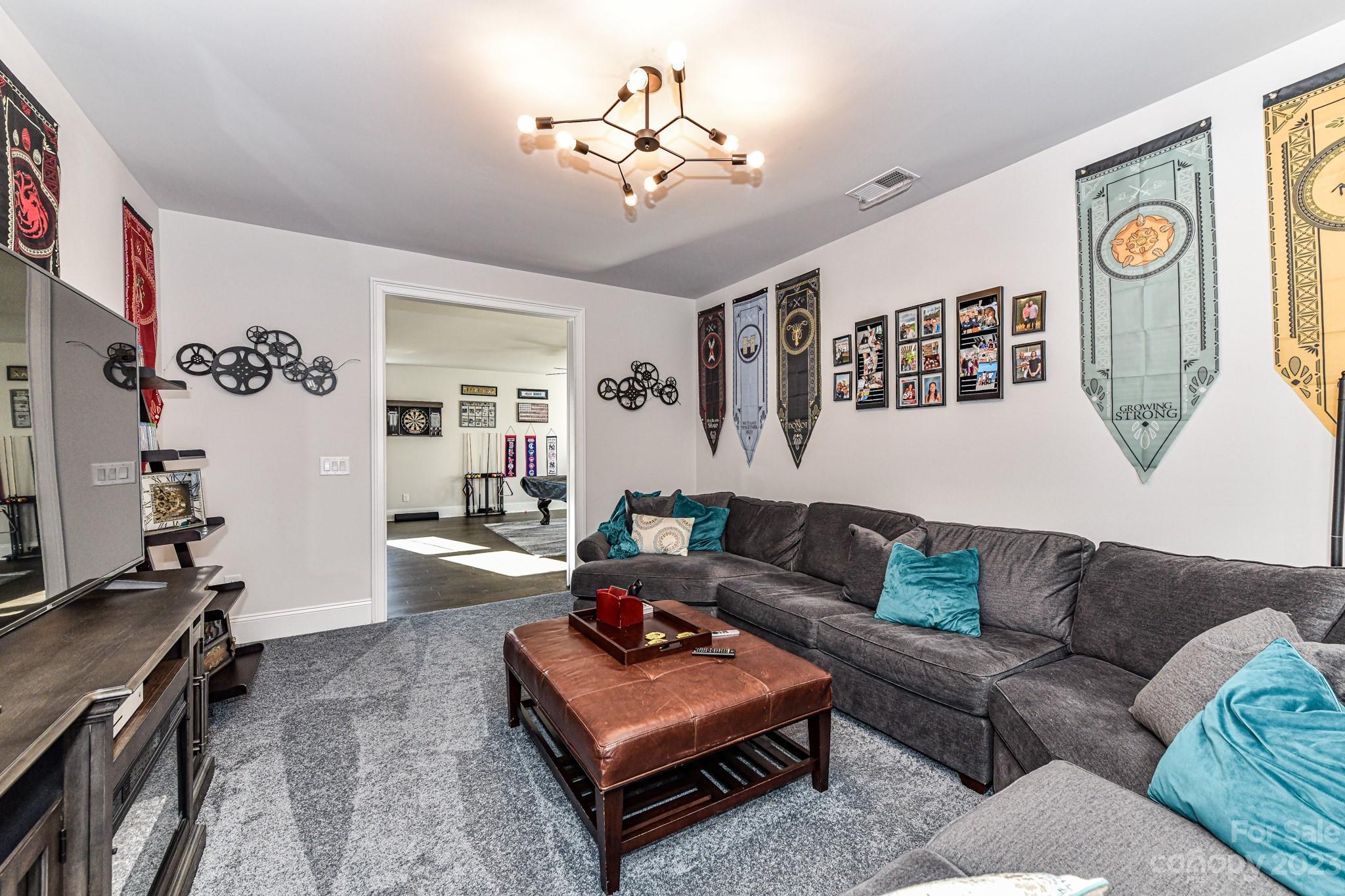 125 Turtleback Ridge, Unit 122 Matthews, NC 28104 - Photo 31 of 40 a living room with furniture and a flat screen tv