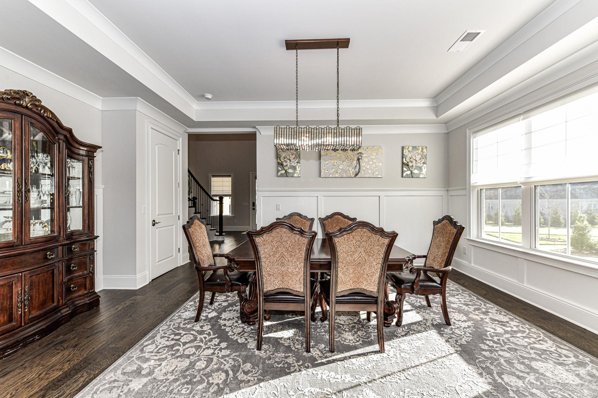 125 Turtleback Ridge, Unit 122 Matthews, NC 28104 - Photo 5 of 40 a view of a dining room with furniture window and wooden floor