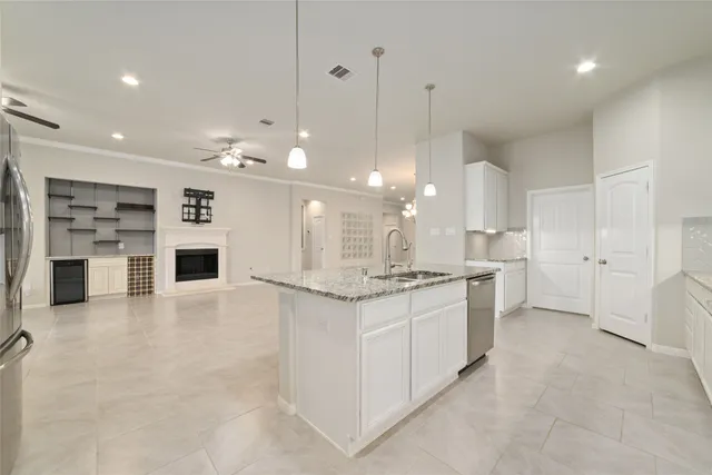 a front view of a house with potted plants