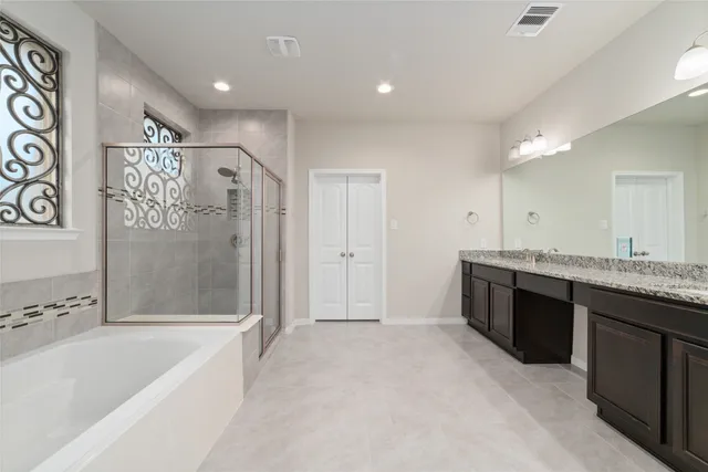 a bathroom with a bathtub and shower