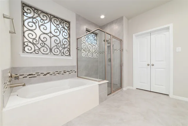 a bedroom with a bed and a large window