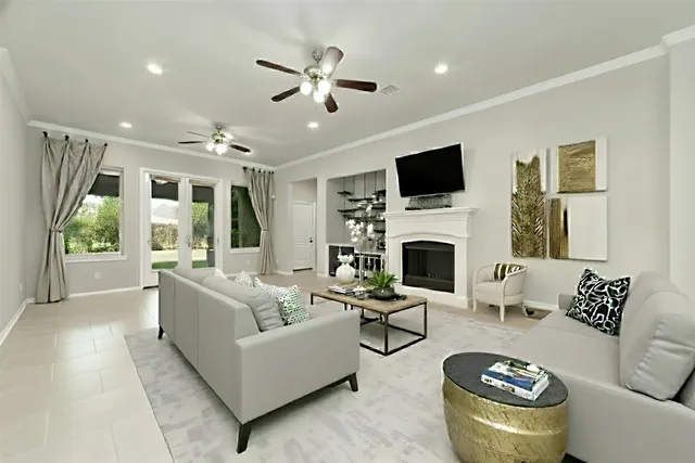 an empty room with windows and fireplace