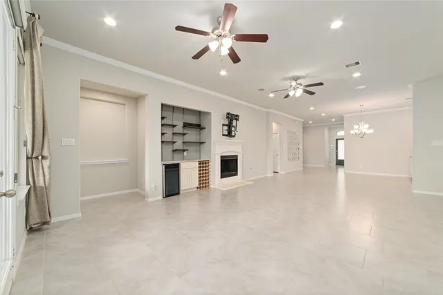 a view of a hallway with a dining table chairs and a refrigerator