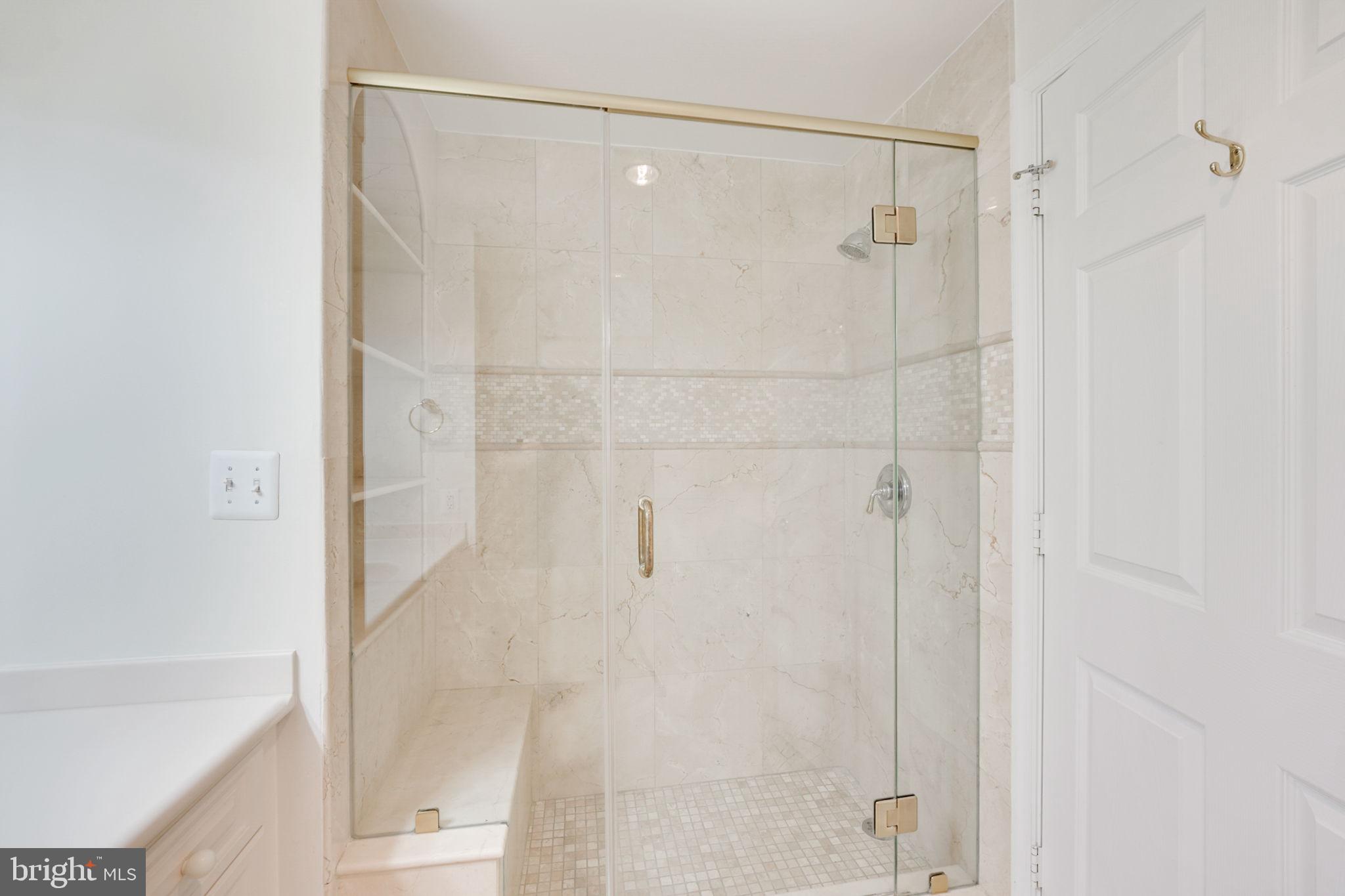 19355 Cypress Ridge Terrace, Unit 1111 Leesburg, VA 20176 - Photo 25 of 47 Walk in shower with custom bench and shelving. WOW