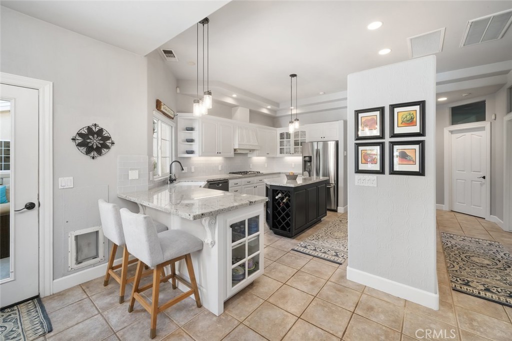 155 Conover Lane Templeton, CA 93465 - Photo 20 of 75 a kitchen with stainless steel appliances kitchen island granite countertop a sink and cabinets