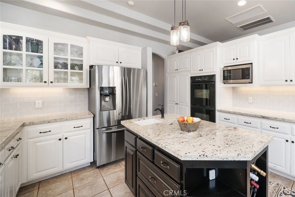 155 Conover Lane Templeton, CA 93465 - Photo 22 of 75 a kitchen with stainless steel appliances granite countertop a sink dishwasher stove and refrigerator with wooden floor