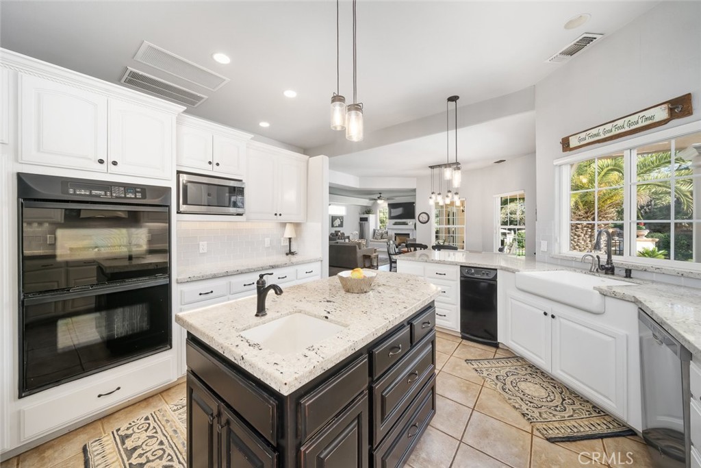 155 Conover Lane Templeton, CA 93465 - Photo 23 of 75 a kitchen with granite countertop a sink stainless steel appliances and white cabinets