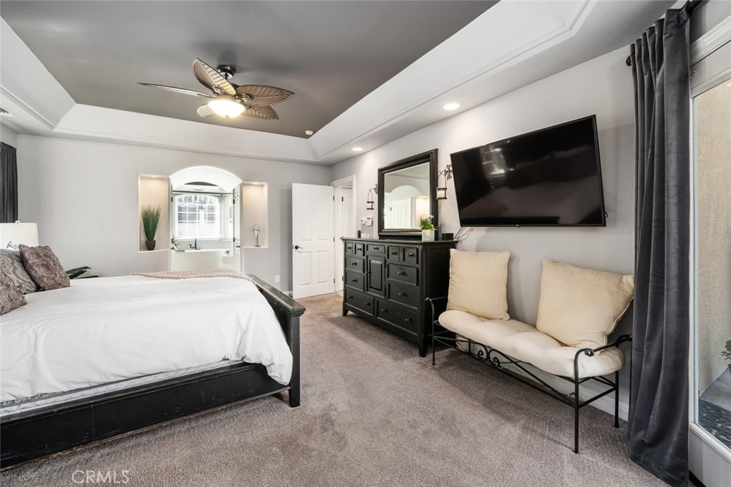 155 Conover Lane Templeton, CA 93465 - Photo 29 of 75 a spacious bedroom with a bed a couch and a flat screen television