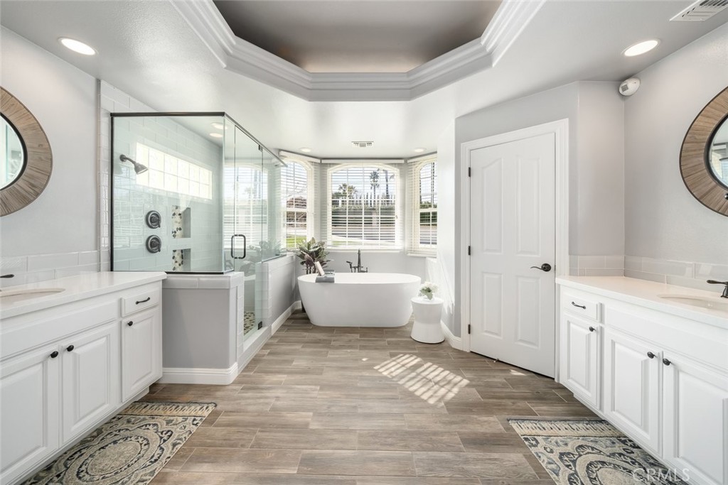 155 Conover Lane Templeton, CA 93465 - Photo 30 of 75 a spacious bathroom with a double vanity sink a mirror and a bathtub