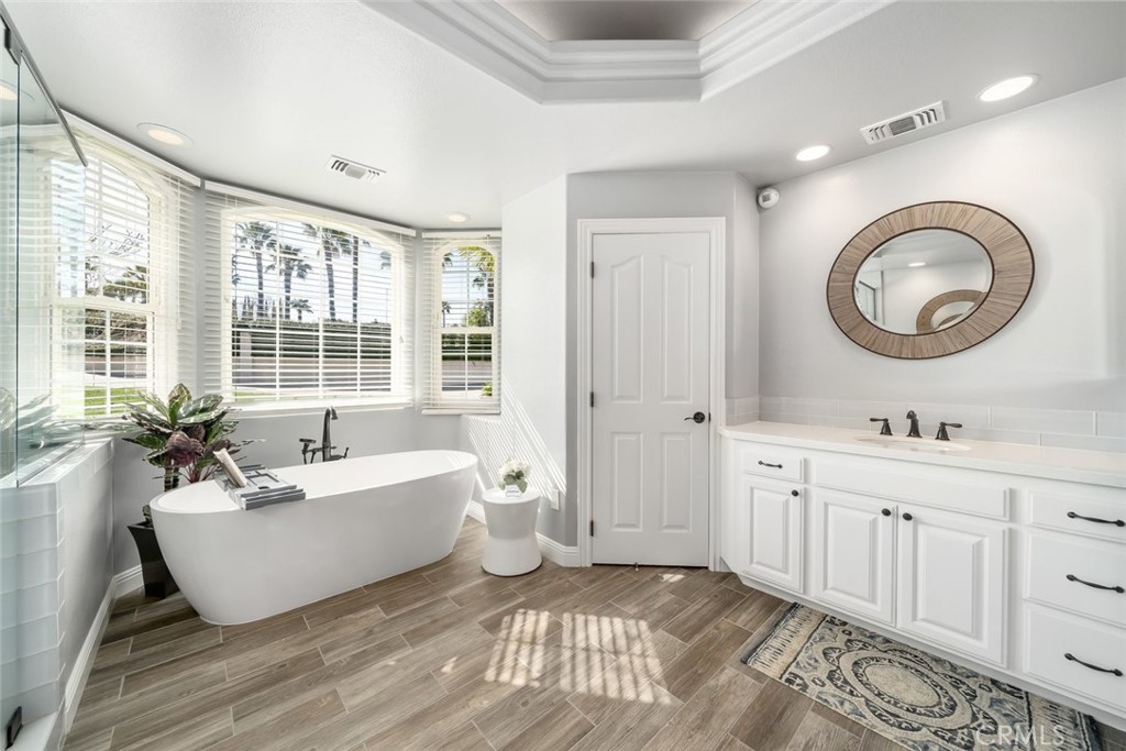 155 Conover Lane Templeton, CA 93465 - Photo 32 of 75 a spacious bathroom with a double vanity sink a mirror and a bathtub