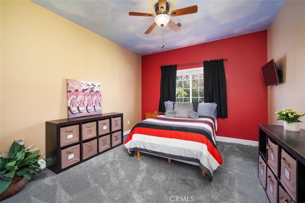 155 Conover Lane Templeton, CA 93465 - Photo 34 of 75 a bedroom with a bed and a chandelier