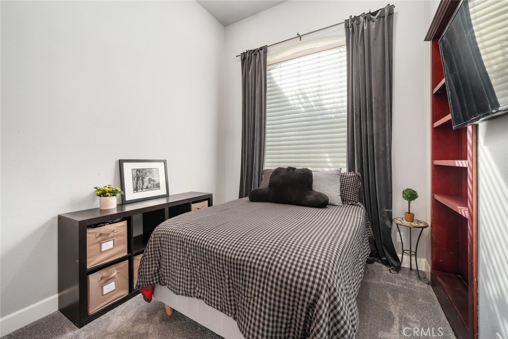 155 Conover Lane Templeton, CA 93465 - Photo 37 of 75 a bedroom with a bed and a flat tv screen on a dresser