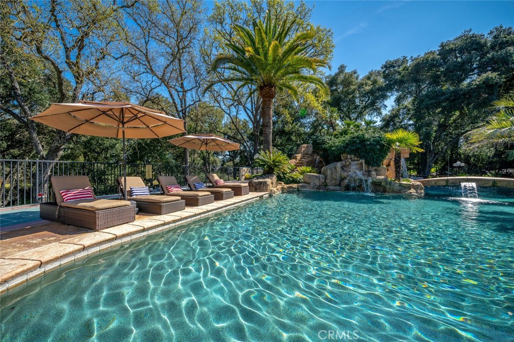 155 Conover Lane Templeton, CA 93465 - Photo 61 of 75 a view of a patio with table and chairs under an umbrella with large trees