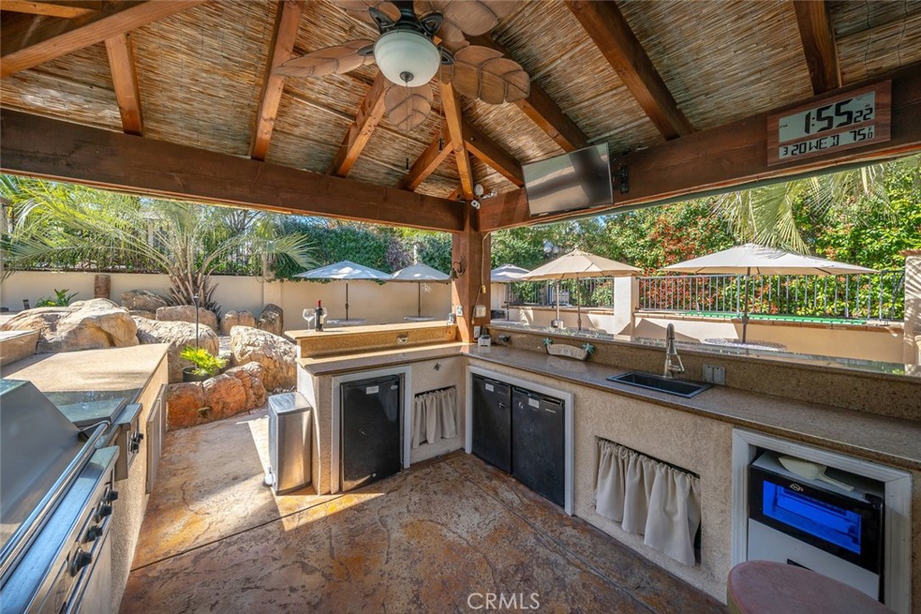155 Conover Lane Templeton, CA 93465 - Photo 66 of 75 a kitchen with stainless steel appliances granite countertop a sink a stove top oven a barbeque oven and a dining table