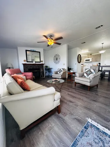 a living room with furniture a dining table and chairs
