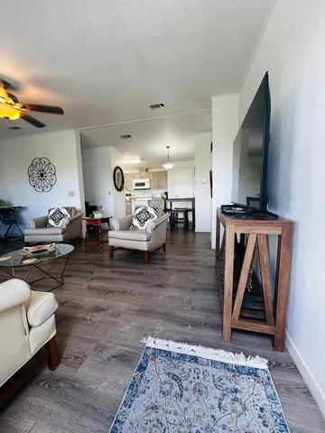 a kitchen with cabinets wooden floor and stainless steel appliances