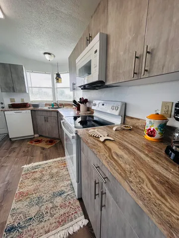 a view of a dining room with furniture a chandelier and wooden floor
