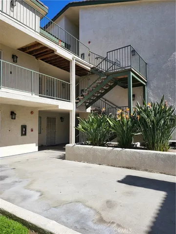 a view of a white building with a outdoor space