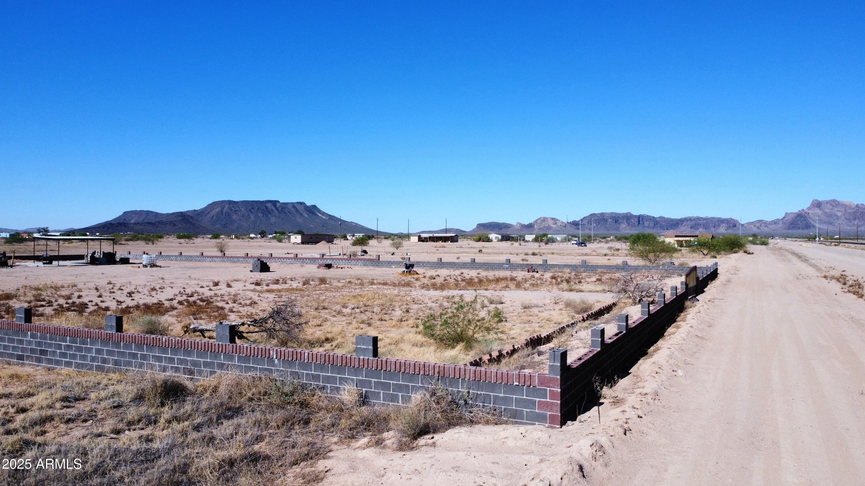 535-xx West Baseline Road, Unit 168 Tonopah, AZ 85354 - Photo 2 of 4 a view of a dry yard with mountains in the background