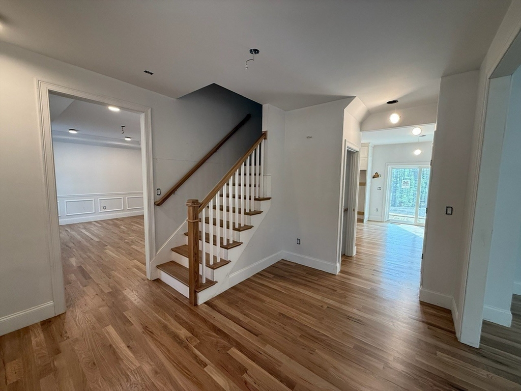 120 Maple Street Stow, MA 01775 - Photo 18 of 36 a view of a hallway with wooden floor and stairs