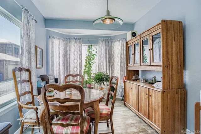 a view of a dining room with furniture window and outside view