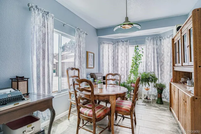 a view of a dining room with furniture window and wooden floor