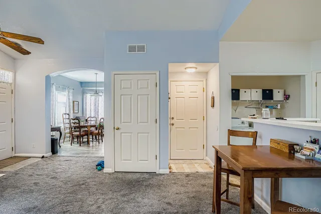 a living room with kitchen island furniture and a table