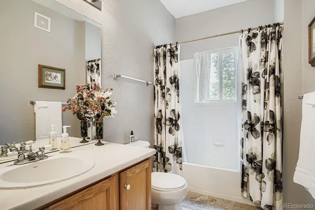 a bathroom with a sink toilet tub and shower