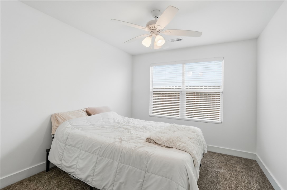 728 East Northern Avenue Springfield, OH 45503 - Photo 23 of 35 This bright bedroom features a ceiling fan, carpet flooring, and ample natural light.