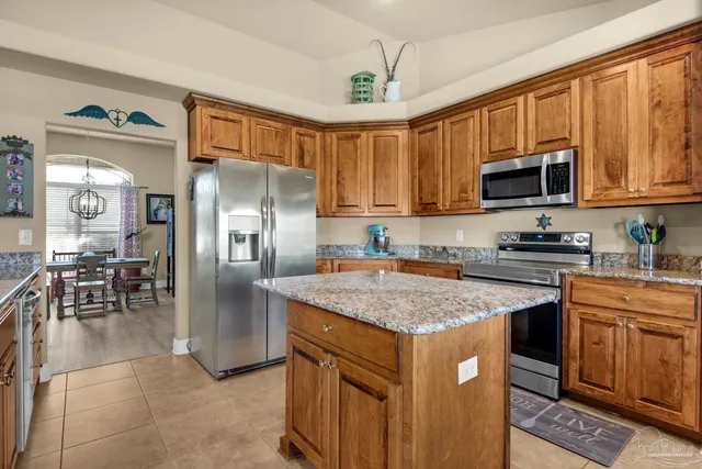 a kitchen with a stove a sink and a refrigerator
