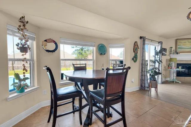 a dining room with furniture window wooden floor and a chandelier