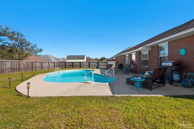a view of a swimming pool with a patio