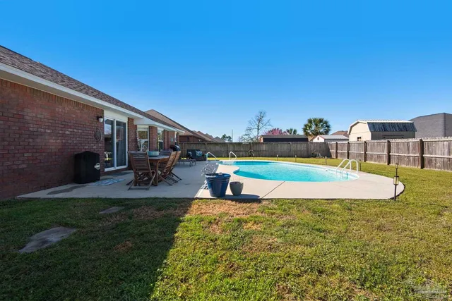 a view of a swimming pool with a yard