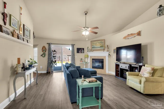 a living room with furniture a fireplace and a flat screen tv