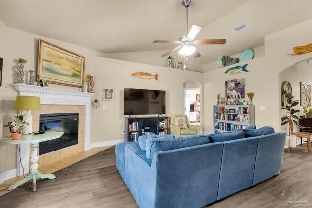 a living room with furniture and a fireplace