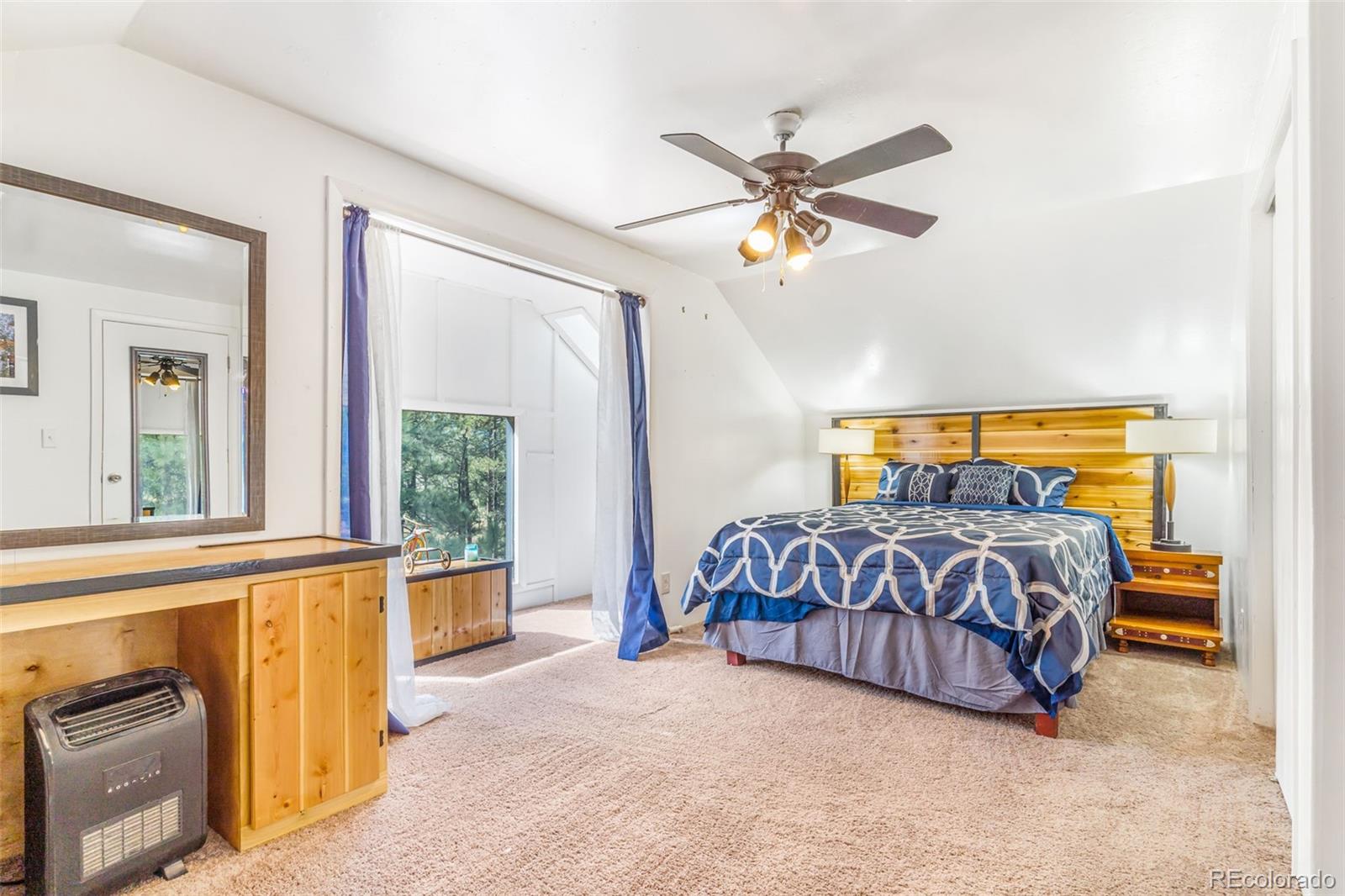 145 Bailey Drive Bailey, CO 80421 - Photo 11 of 21 a bedroom with a bed and a window