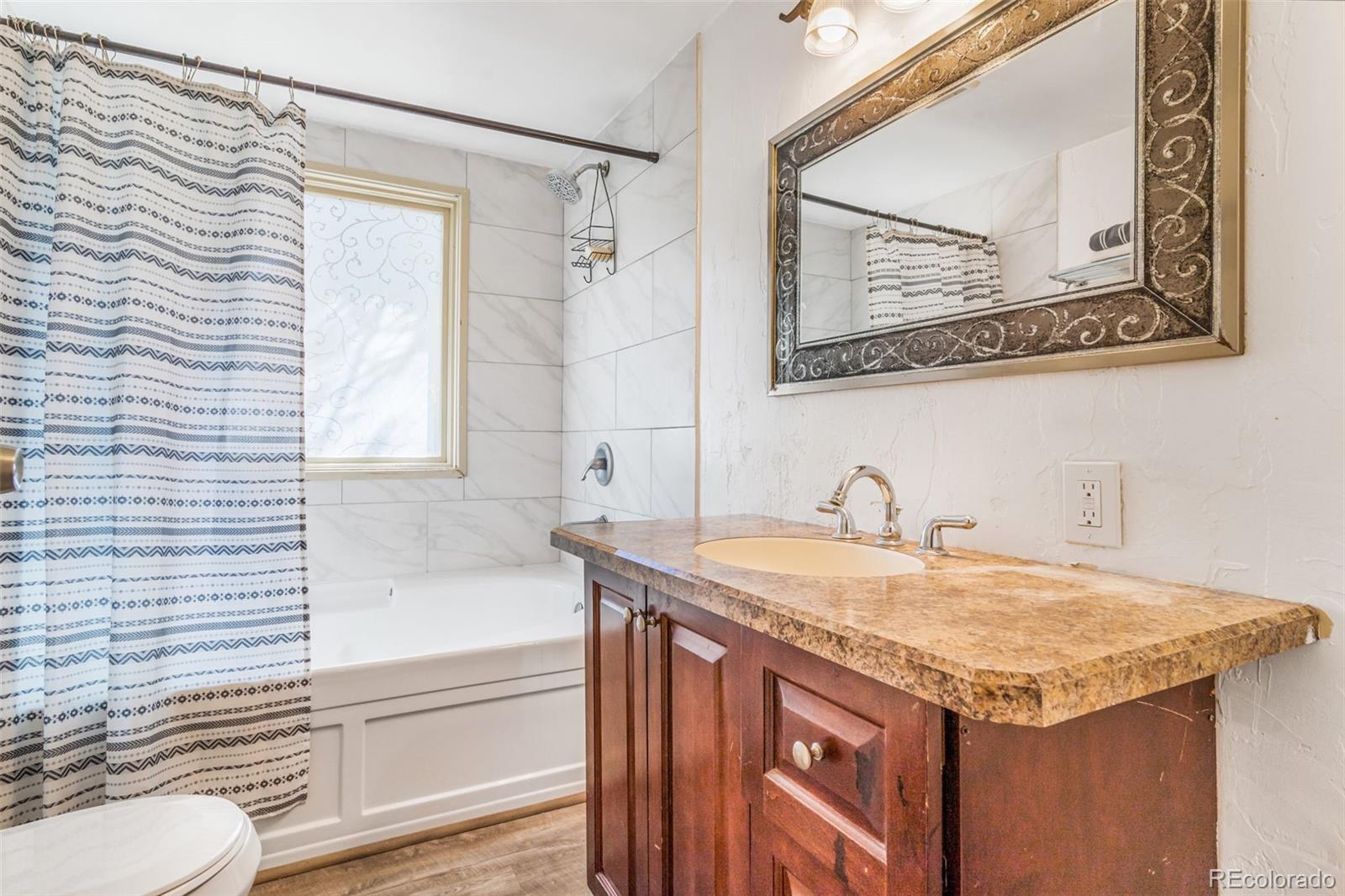 145 Bailey Drive Bailey, CO 80421 - Photo 15 of 21 a bathroom with a granite countertop sink and a mirror