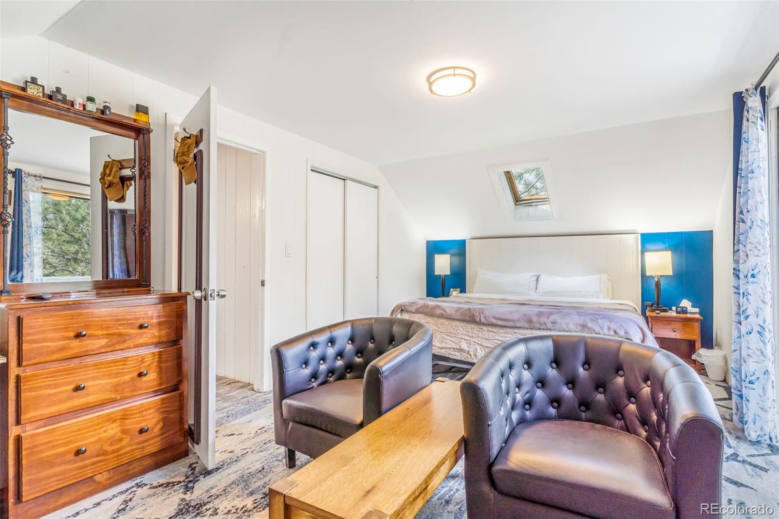 145 Bailey Drive Bailey, CO 80421 - Photo 16 of 21 a bedroom with a bed and wooden floor