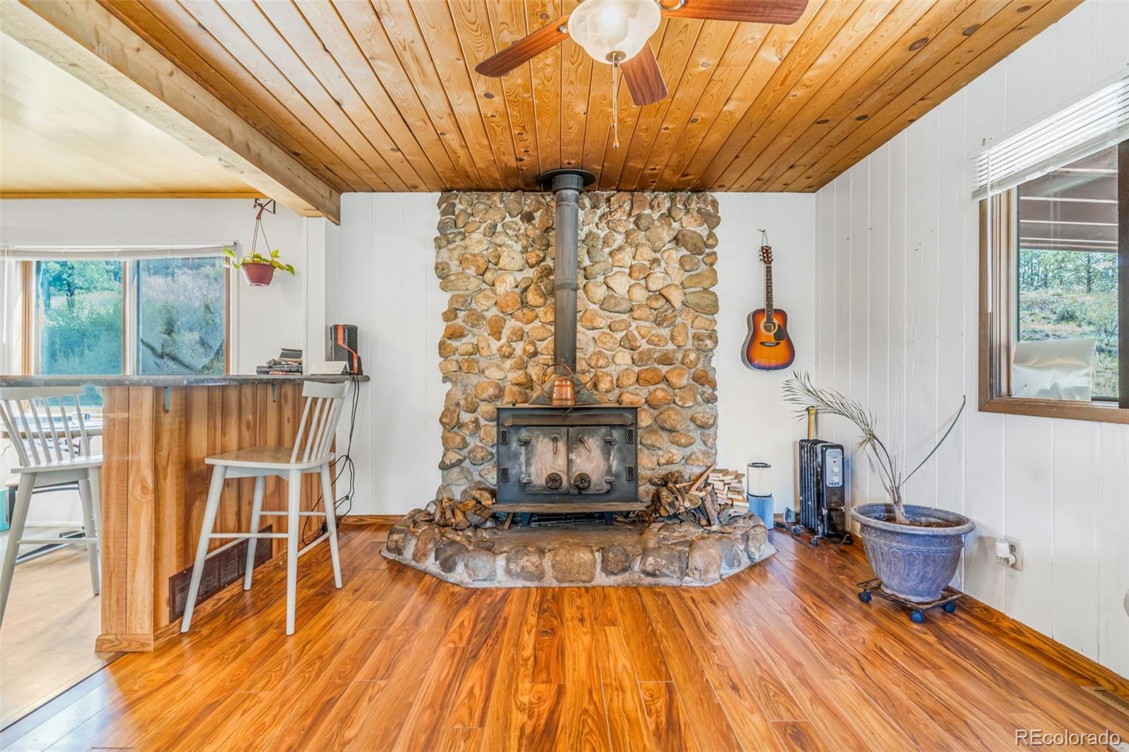 145 Bailey Drive Bailey, CO 80421 - Photo 5 of 21 a living room with furniture and a fireplace