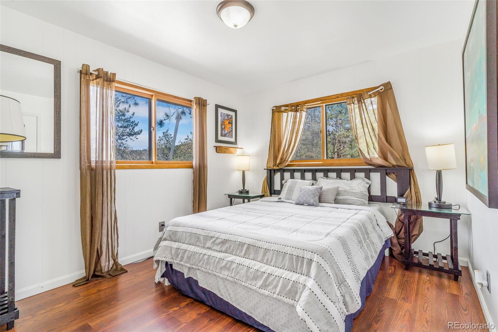 145 Bailey Drive Bailey, CO 80421 - Photo 9 of 21 a bedroom with a bed and wooden floor