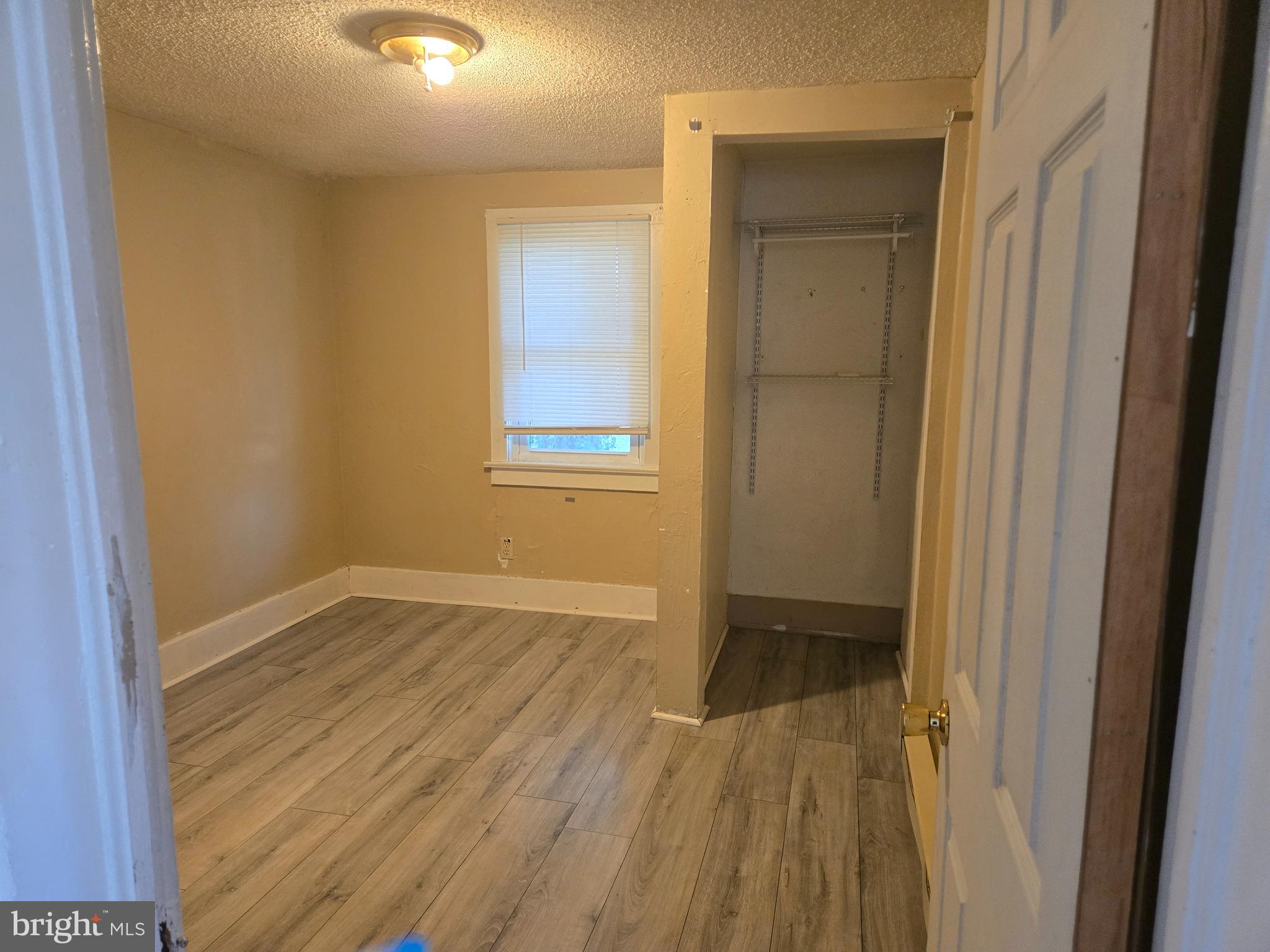 37 Asbury Avenue Dover, DE 19901 - Photo 11 of 16 a view of an empty room with wooden floor and a window