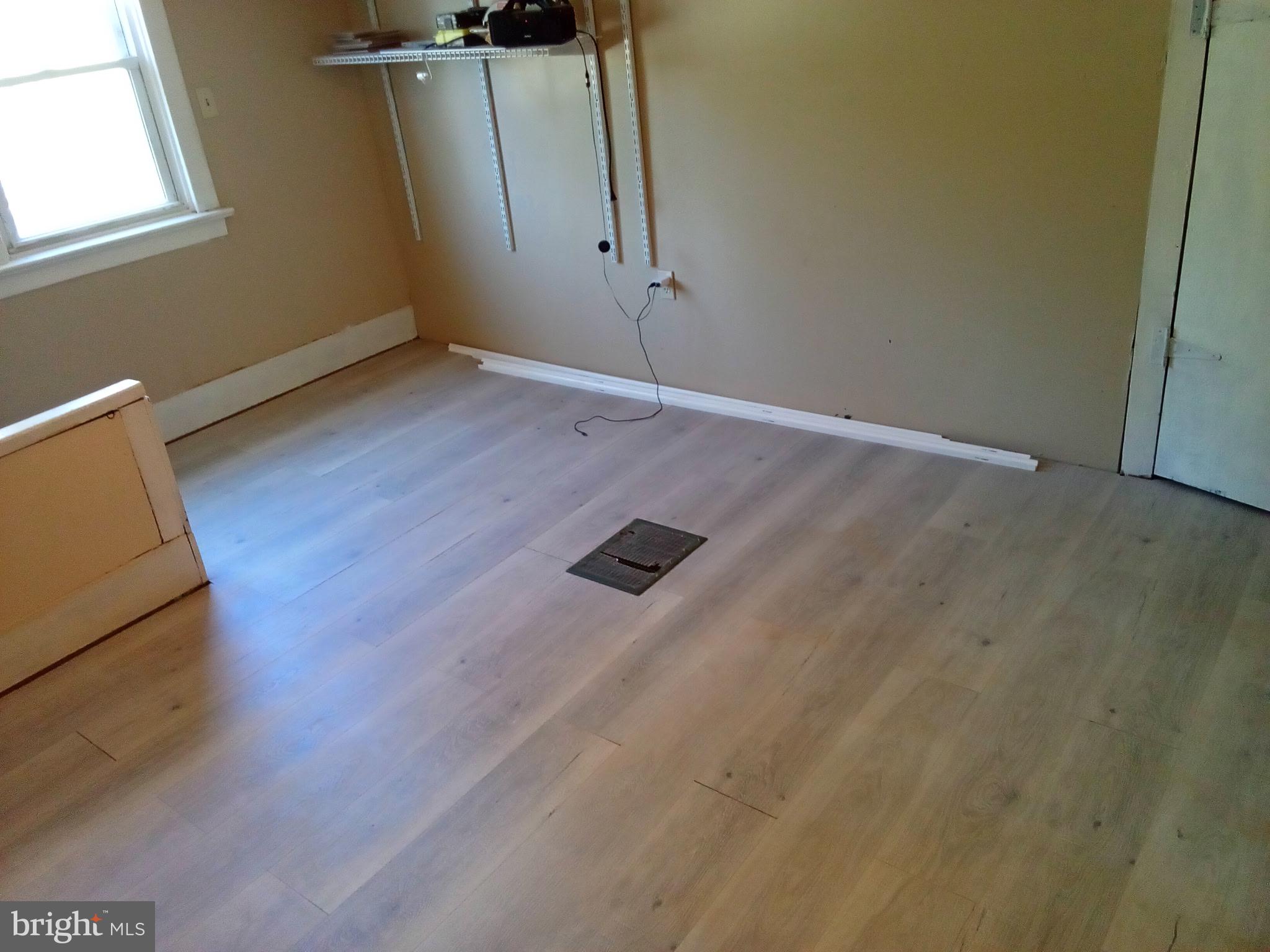 37 Asbury Avenue Dover, DE 19901 - Photo 15 of 16 an empty room with wooden floor