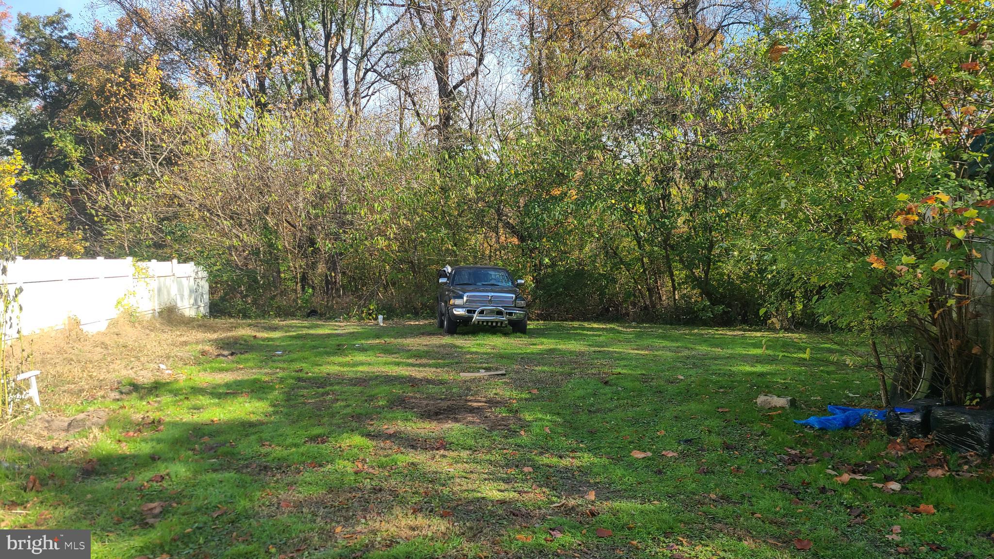 37 Asbury Avenue Dover, DE 19901 - Photo 16 of 16 a backyard of a house with trees and outdoor seating