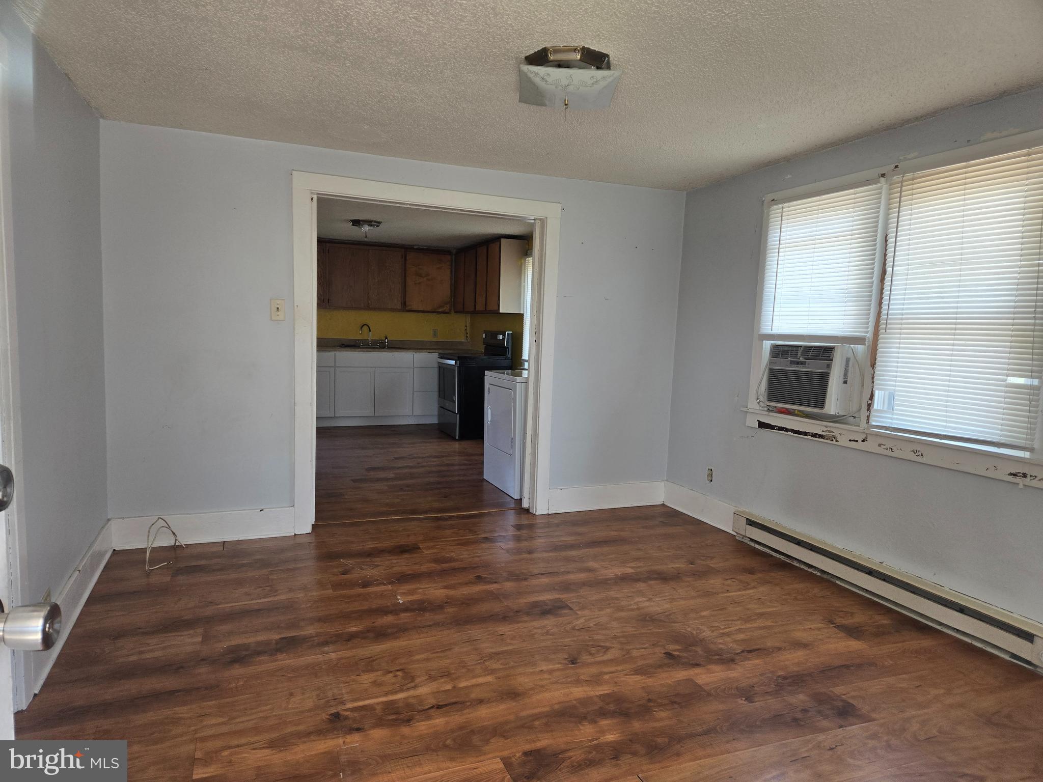 37 Asbury Avenue Dover, DE 19901 - Photo 7 of 16 a view of an empty room with a window and wooden floor