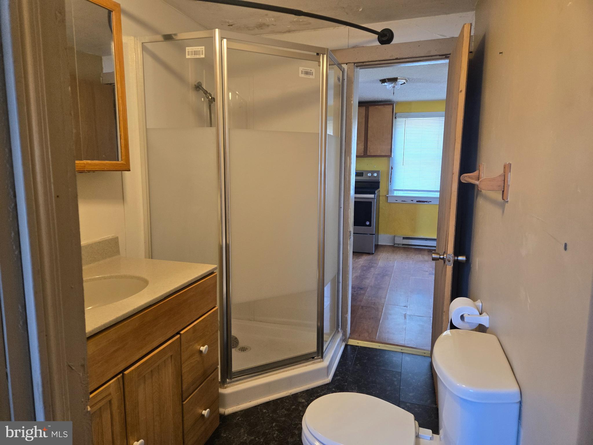 37 Asbury Avenue Dover, DE 19901 - Photo 8 of 16 a bathroom with a granite countertop sink mirror vanity and toilet