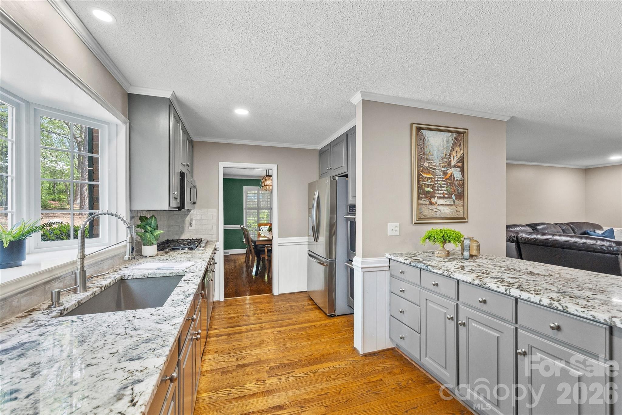10500 Doylestown Road Matthews, NC 28105 - Photo 11 of 46 a large kitchen with kitchen island granite countertop a sink and cabinets