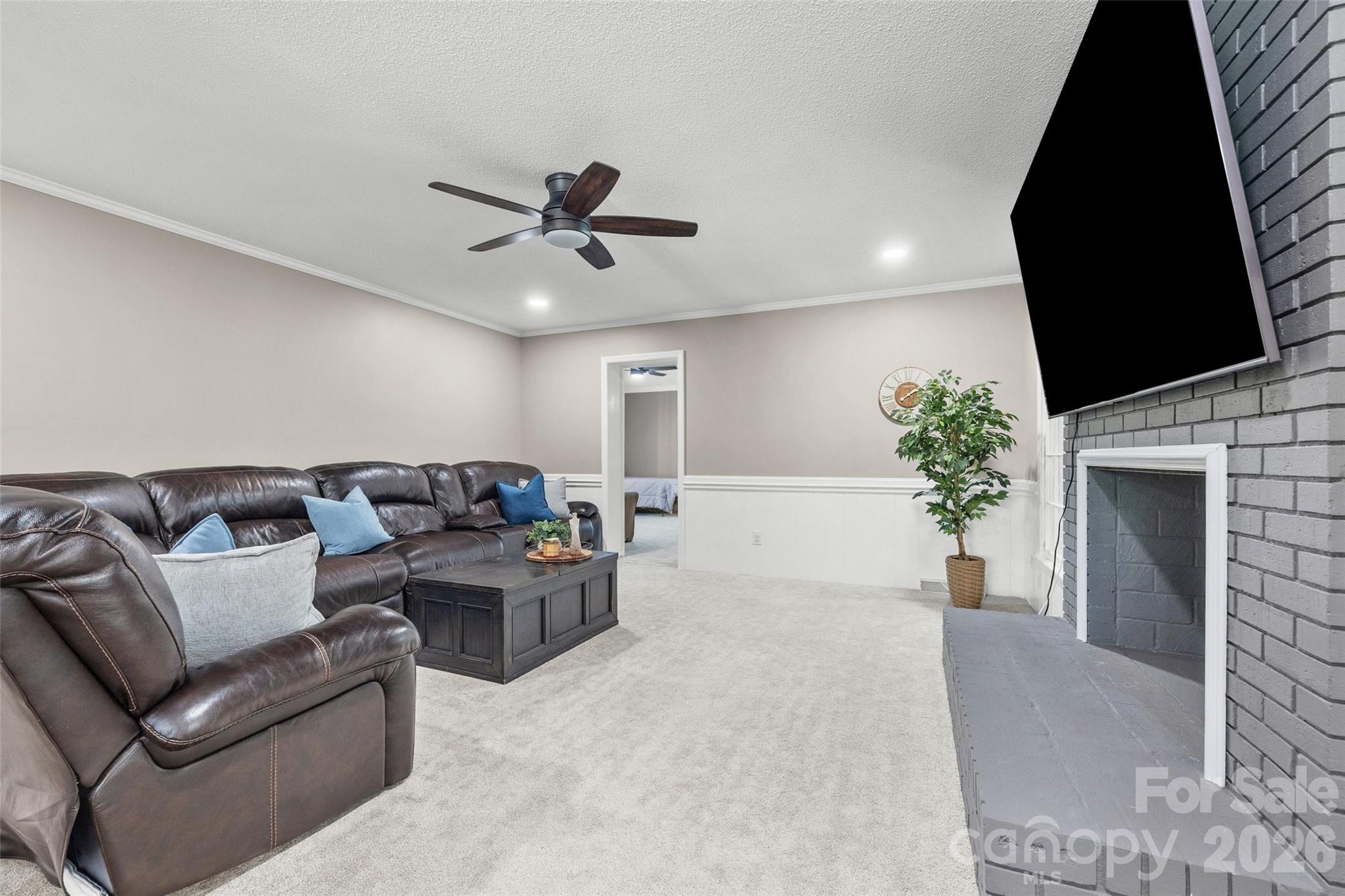10500 Doylestown Road Matthews, NC 28105 - Photo 13 of 46 a living room with furniture a fireplace and a flat screen tv