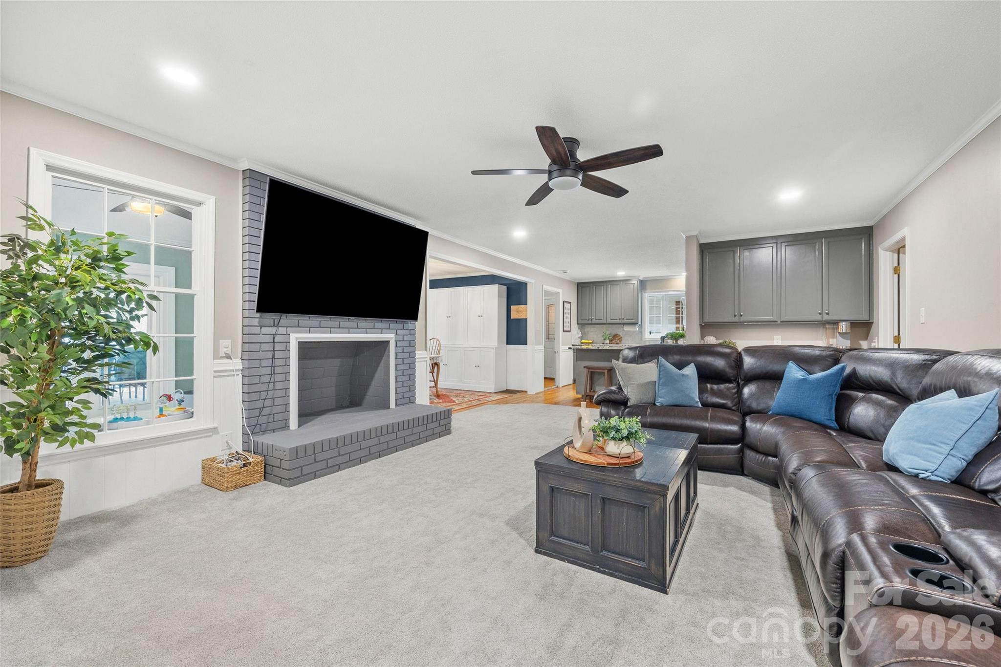 10500 Doylestown Road Matthews, NC 28105 - Photo 14 of 46 a living room with furniture a flat screen tv and a fireplace