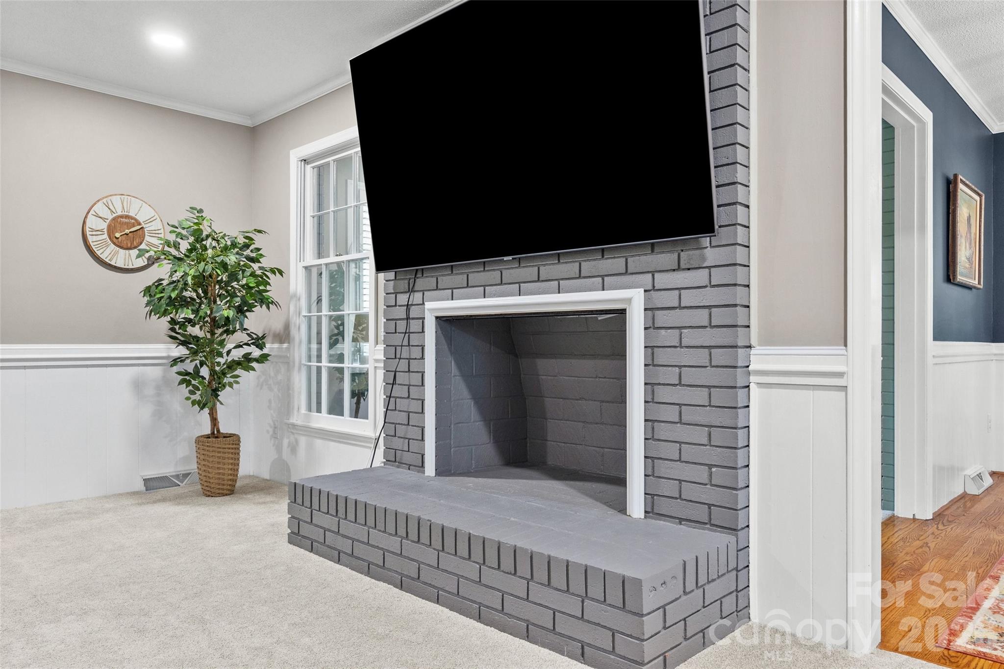 10500 Doylestown Road Matthews, NC 28105 - Photo 15 of 46 a living room with furniture a flat screen tv and a fireplace