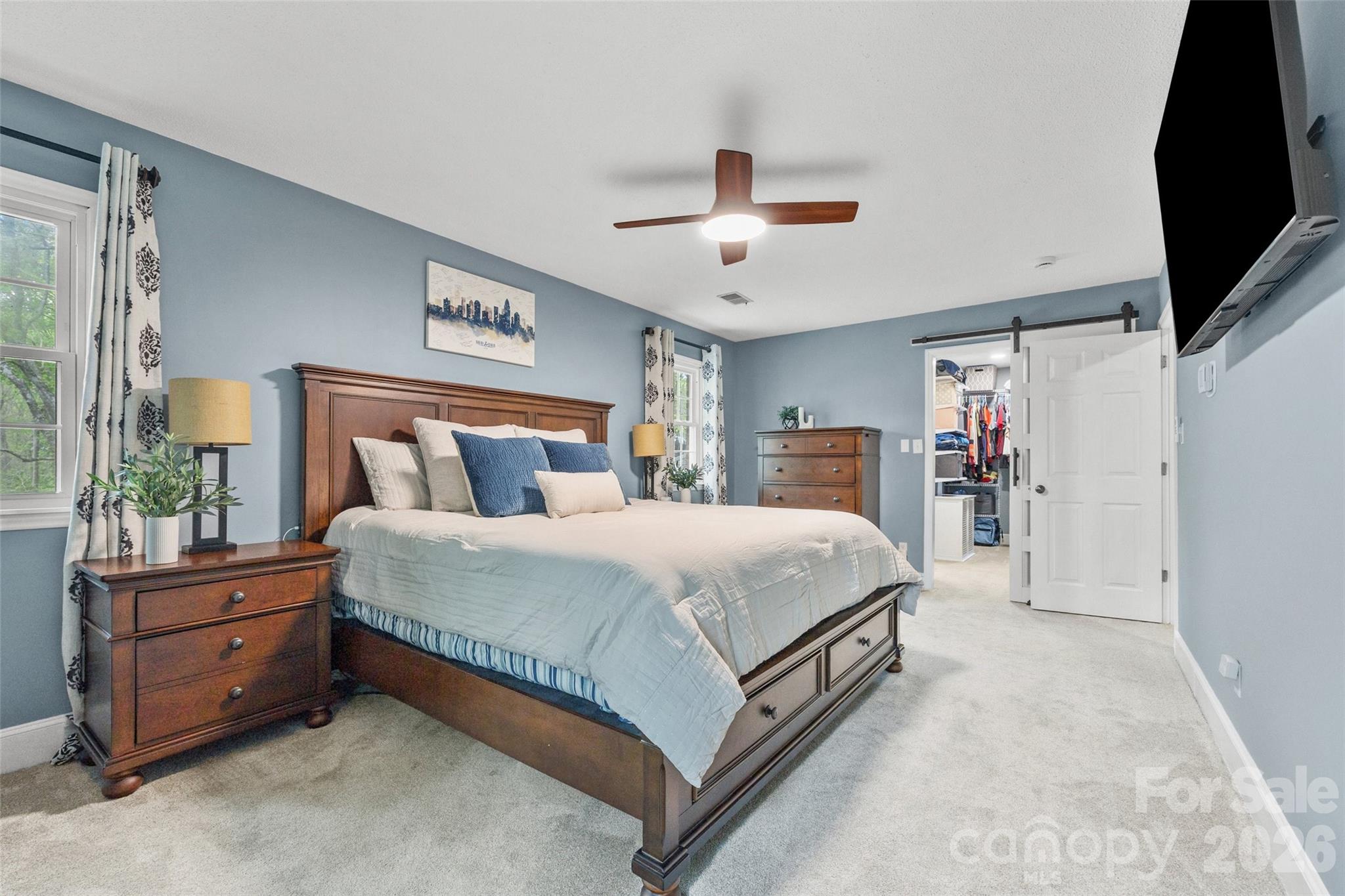 10500 Doylestown Road Matthews, NC 28105 - Photo 30 of 46 a bedroom with a bed and a flat tv screen on dresser